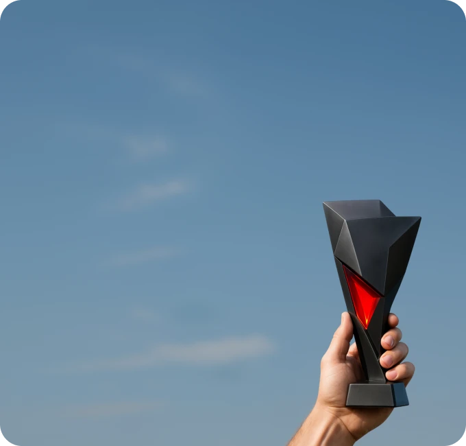 XMTrading affiliates league promotion illustrated with a hand holding a trophy against a clear sky
