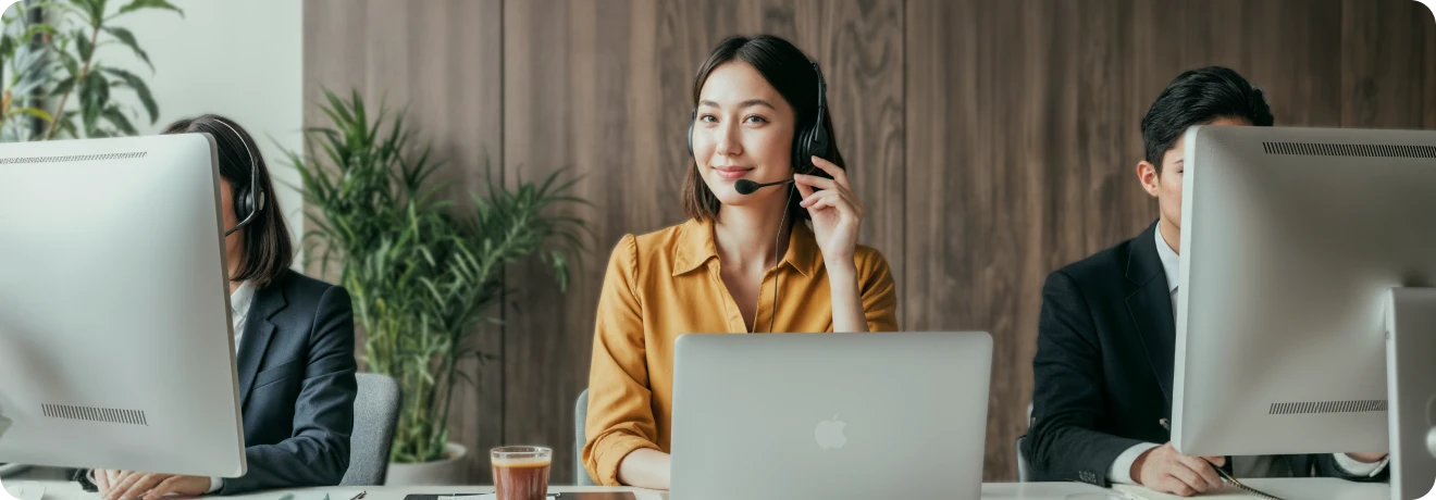 XMTrading support team representative assisting clients with professional, friendly service at a modern help desk.