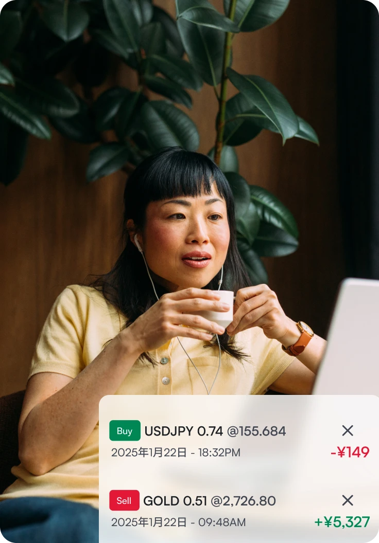 Woman looking at her laptop screen, displaying XMTrading positions for USDJPY and GOLD with profit and loss values.