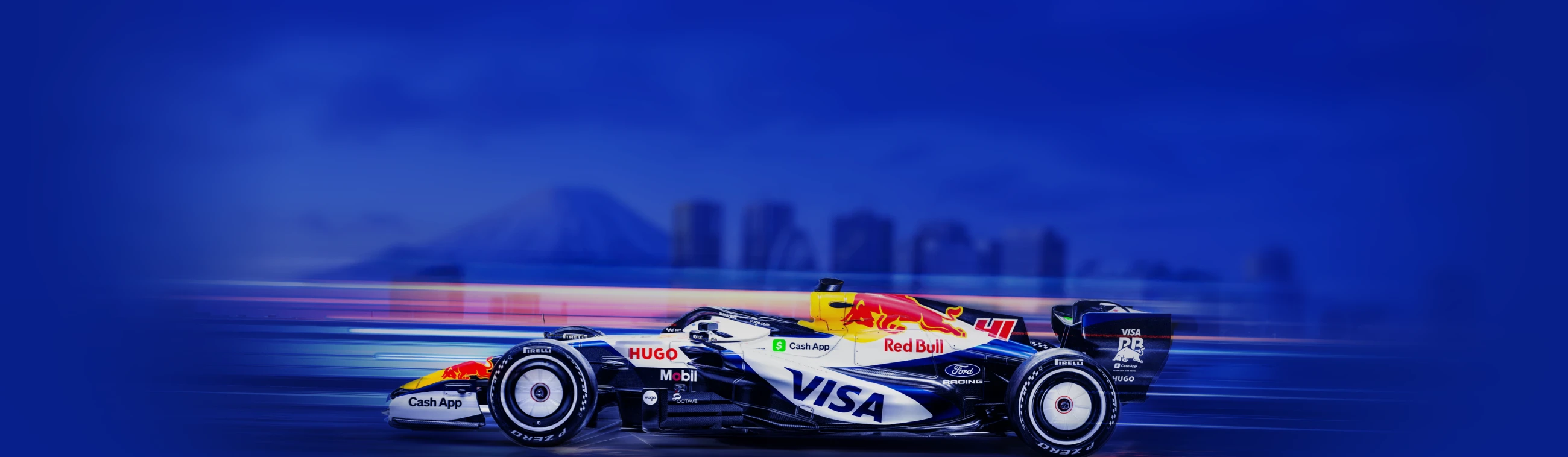 Visa Cash App RB Formula 1 car speeding on the track, representing XMTrading’s sponsorship partnership.